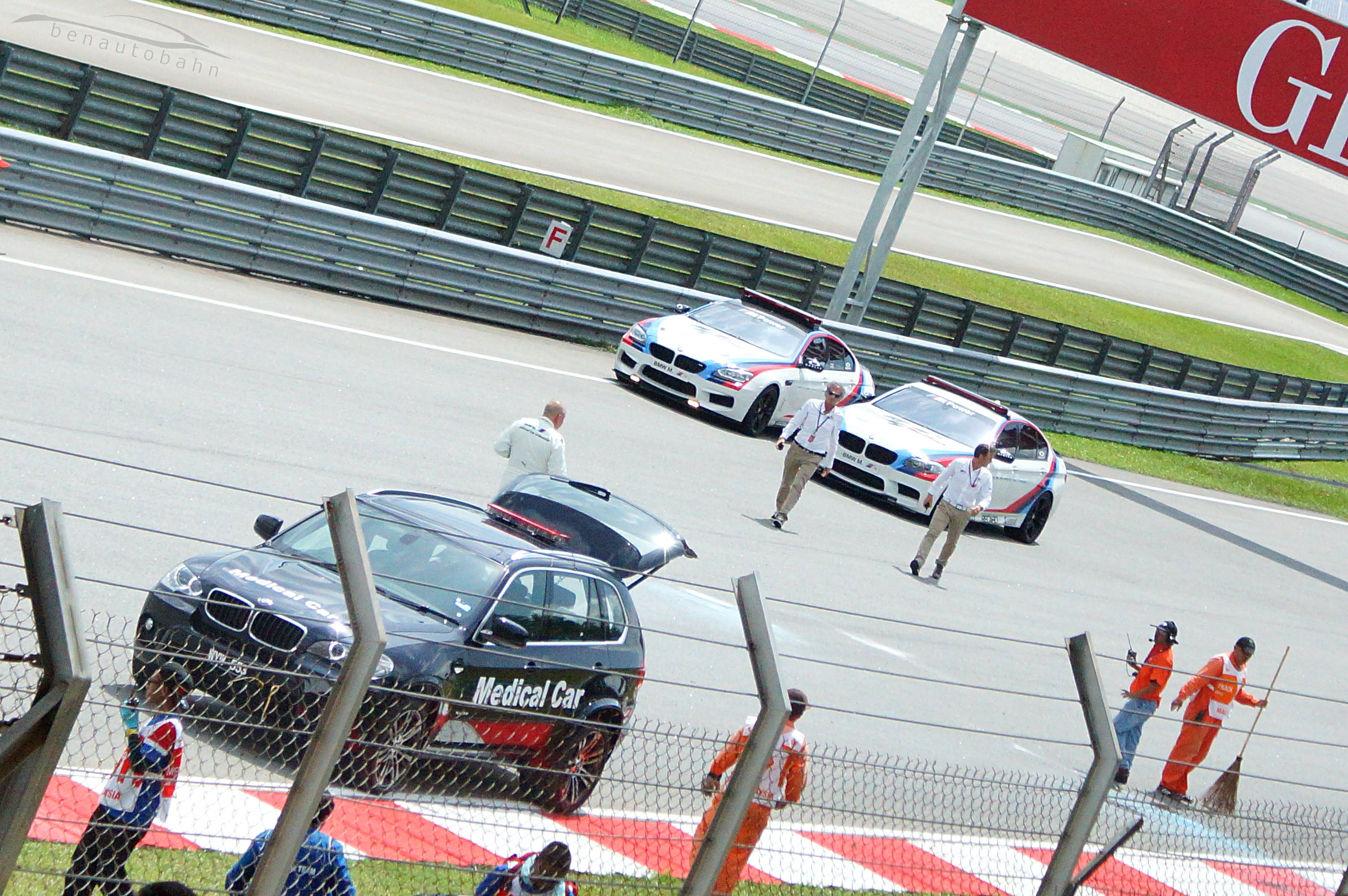 Loris Capirossi (right) and his partner (left) from the M5 Safety Car walking towards the crash site